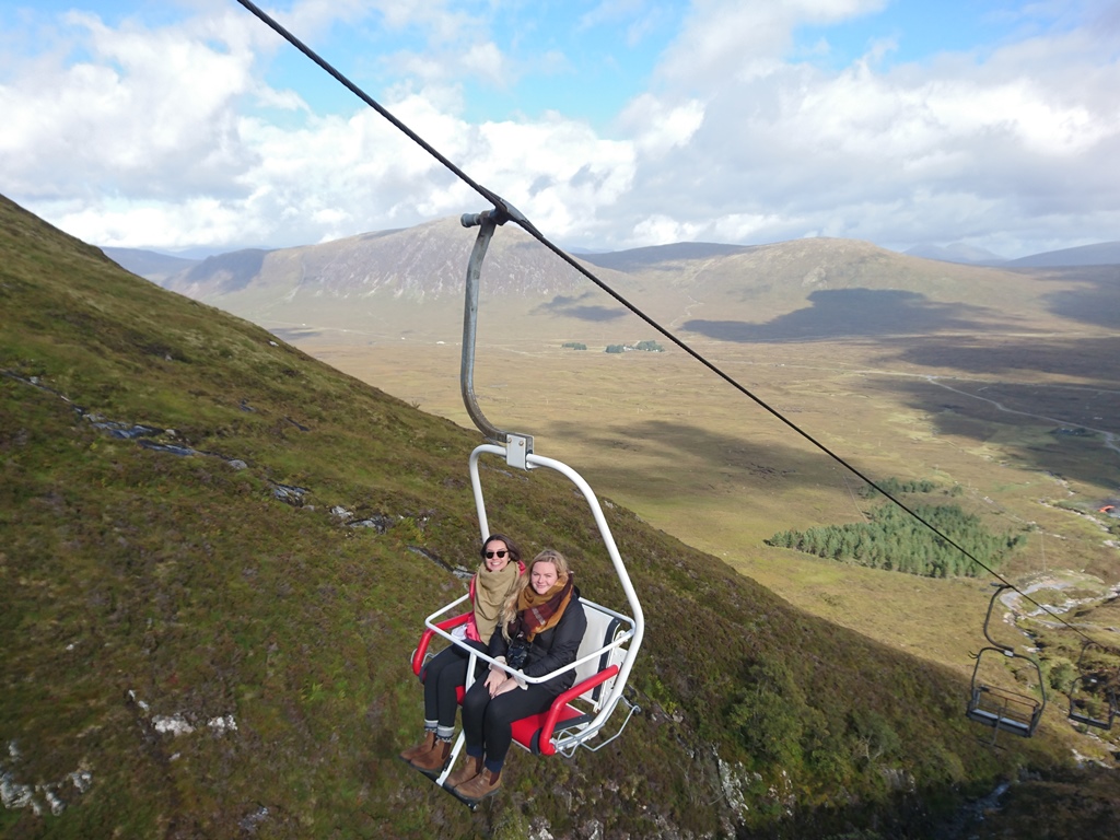 Glencoe Mountain in United Kingdom - a woman sitting in a chair on top of a mountain.