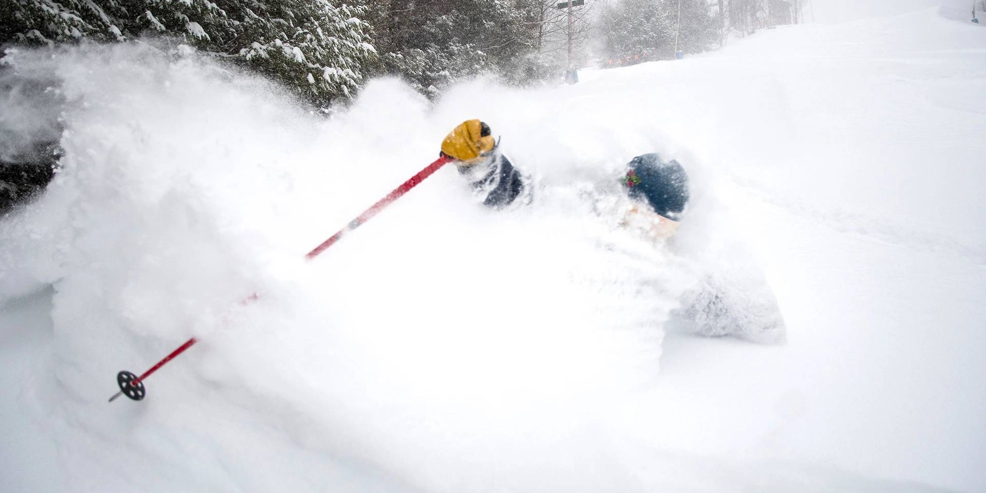 Pleasant Mountain in USA - a person skiing down a hill covered in snow.