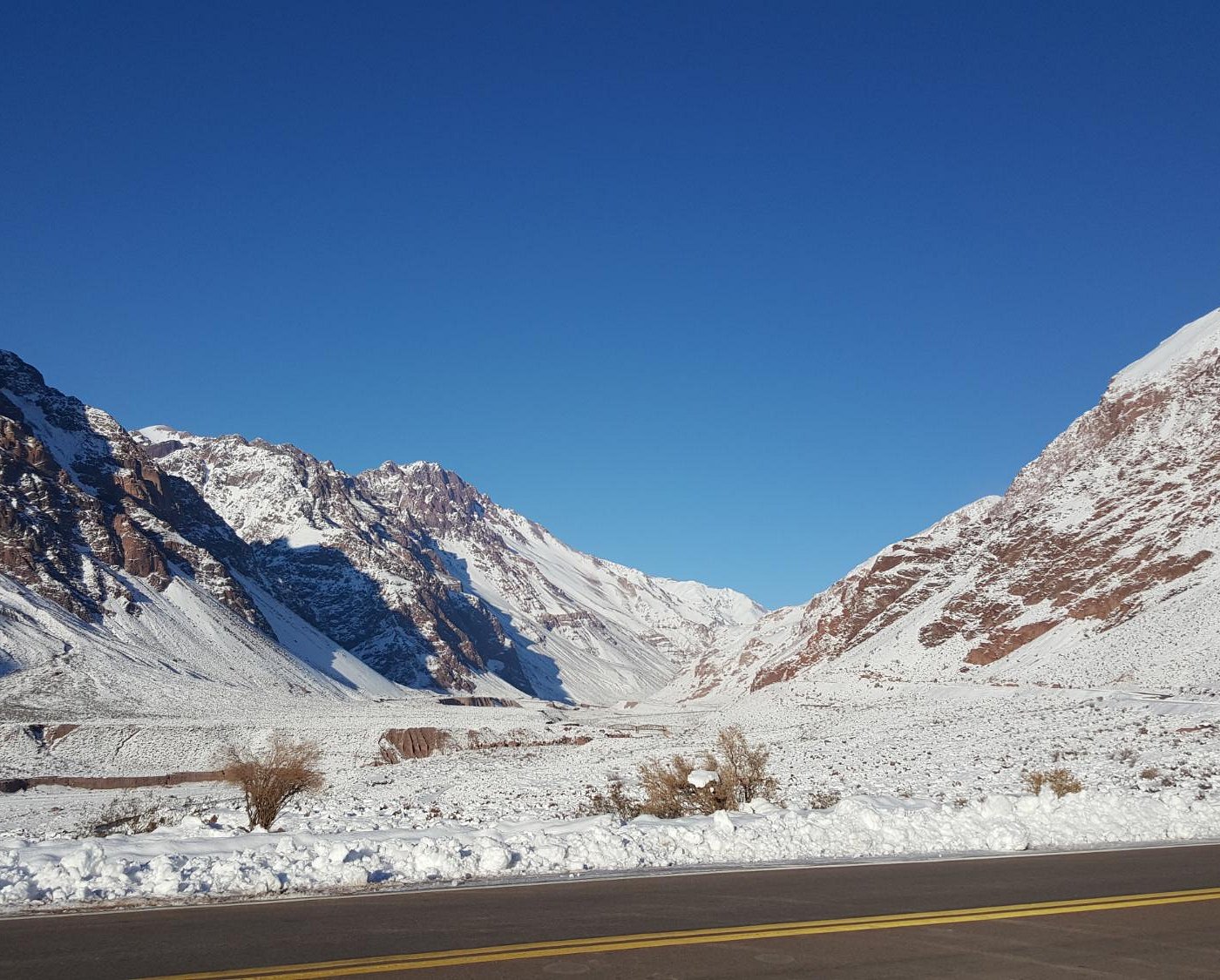 Los Penitentes in Argentina - a car driving down a snowy mountain road.