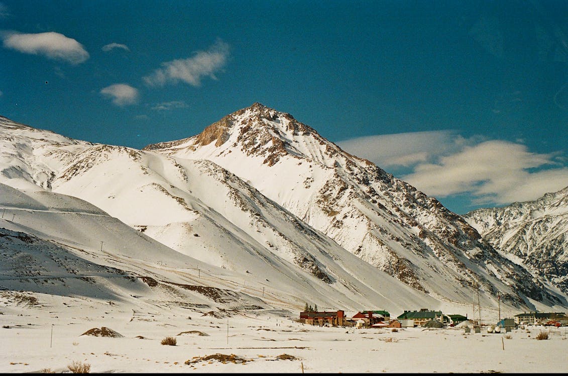Los Penitentes in Argentina - a snow covered mountain with a small town below.
