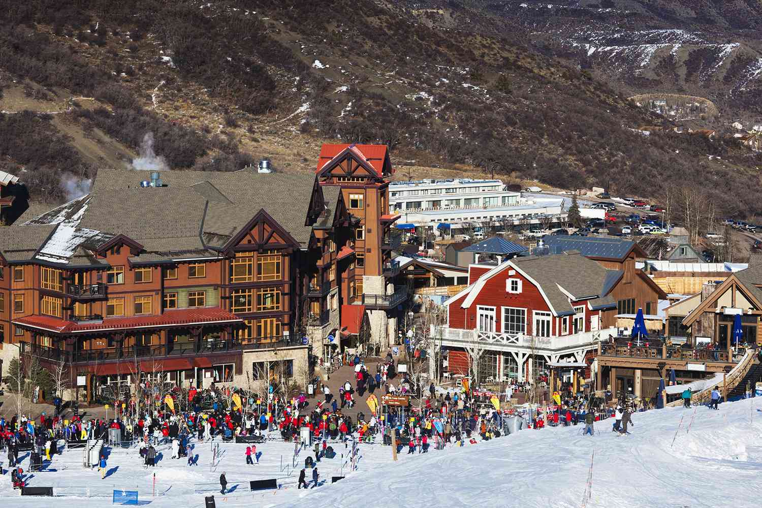 Aspen Snowmass in USA - a large group of people skiing down a hill.