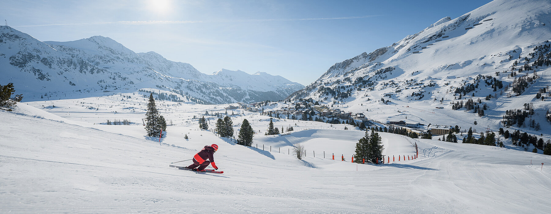 Obertauern in Austria - a person riding a snowboard down a snowy slope.