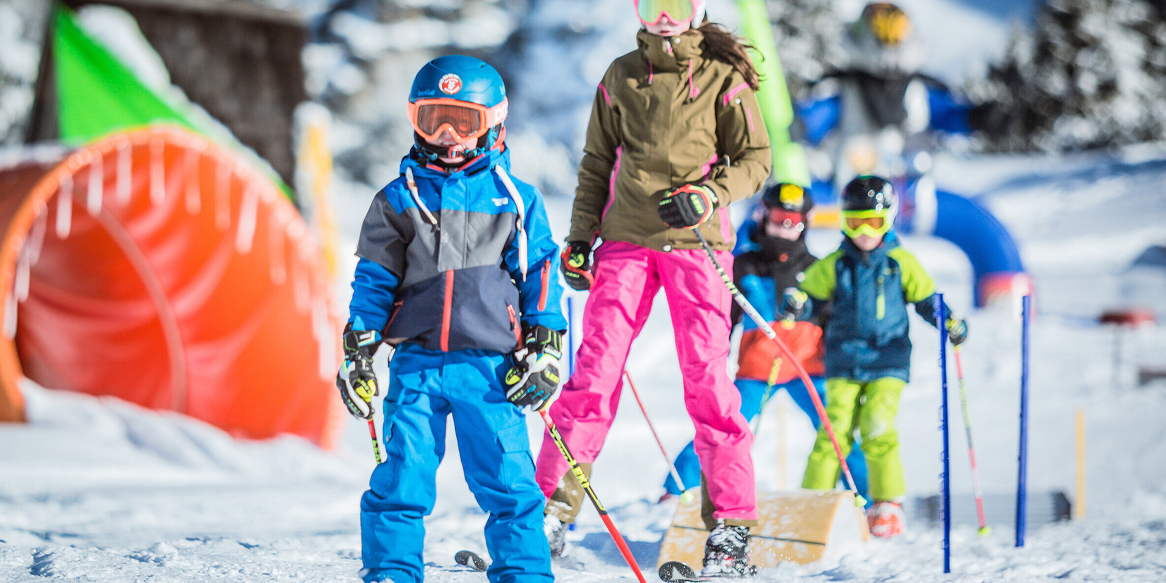 A family and other groups of people enjoying a day of winter sports in the snowy landscape of Obertauern Lungau Salzburg Austria.