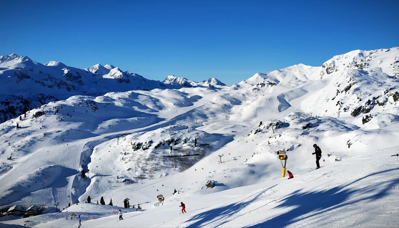 Obertauern in Austria - a group of people skiing down a snowy mountain.