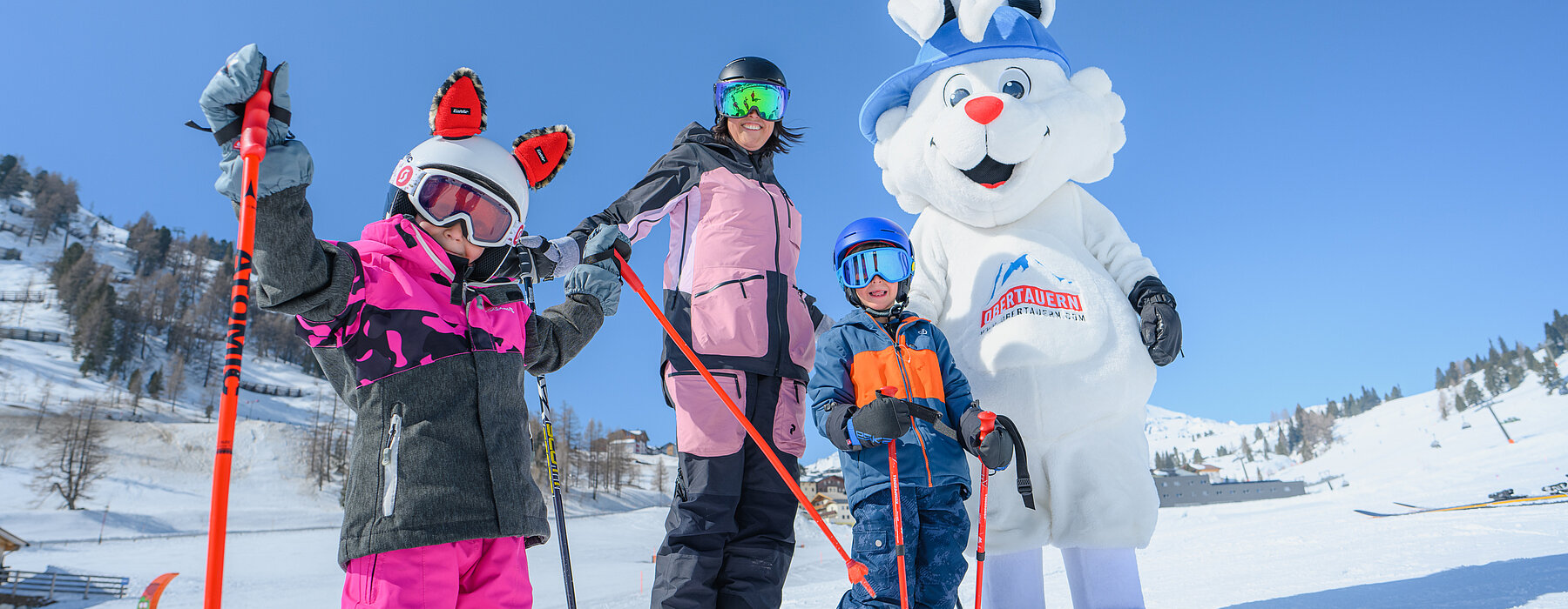 A family enjoying skiing together at the popular winter sports destination of Obertauern in Lungau Salzburg Austria. The vibrant atmosphere of the ski resort is enticing many ski-lovers.
