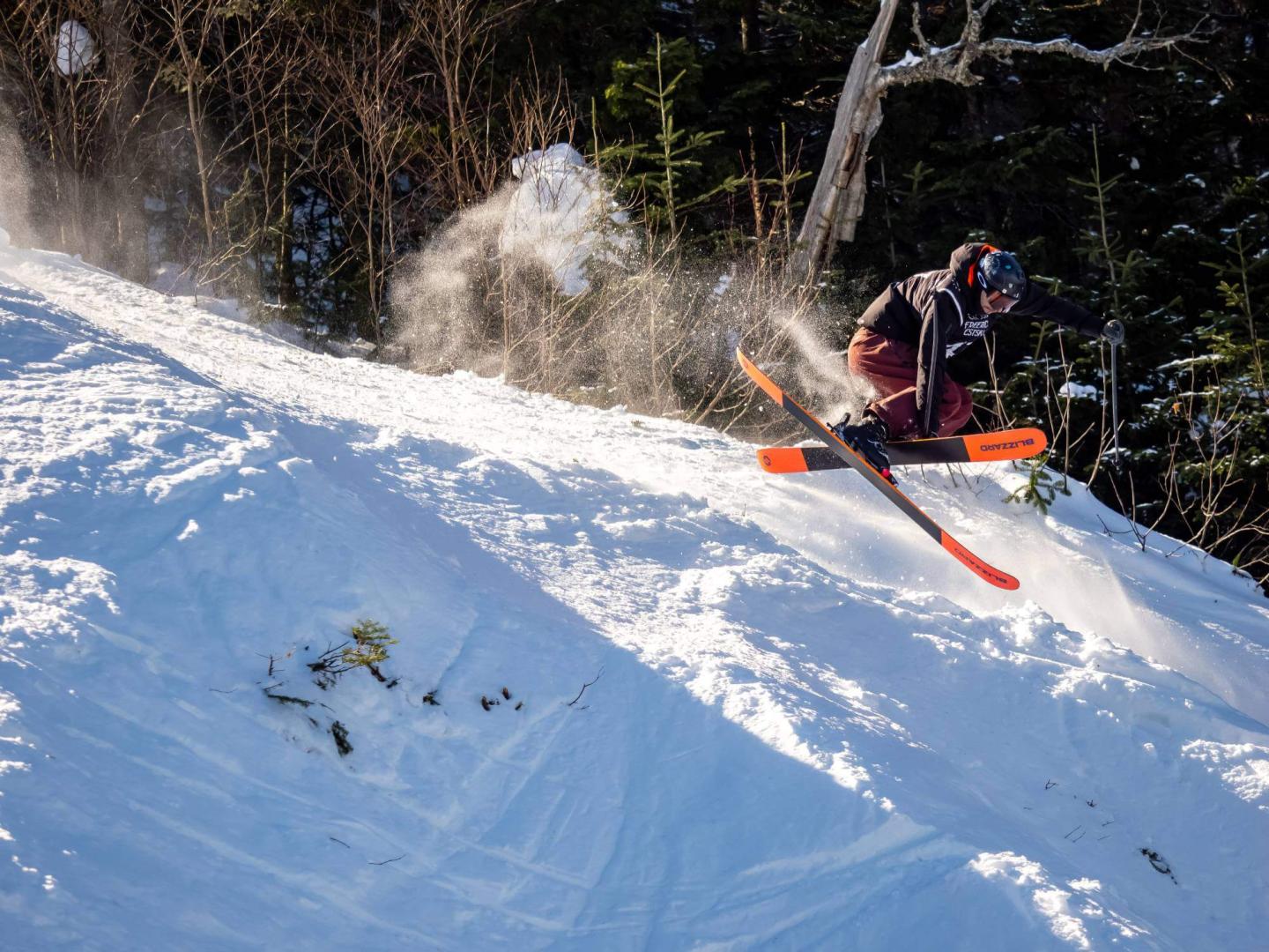 Massif du Sud in Canada - a man riding a snowboard down a snowy slope.