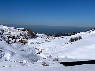 Vibrant winter sports scene at the Zaarour centre in Mamboukh, Lebanon. Stunning winter landscape and a charming chalet nestled amidst the snow-laden slopes.