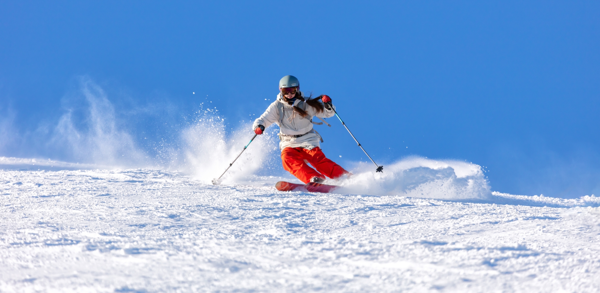 A skier and a snowboarder enjoy a winter sports scene at Yunomaru ski resort in Chūbu, Tomi, Nagano, Honshu, Japan. Snow gleams white on slopes of the center.