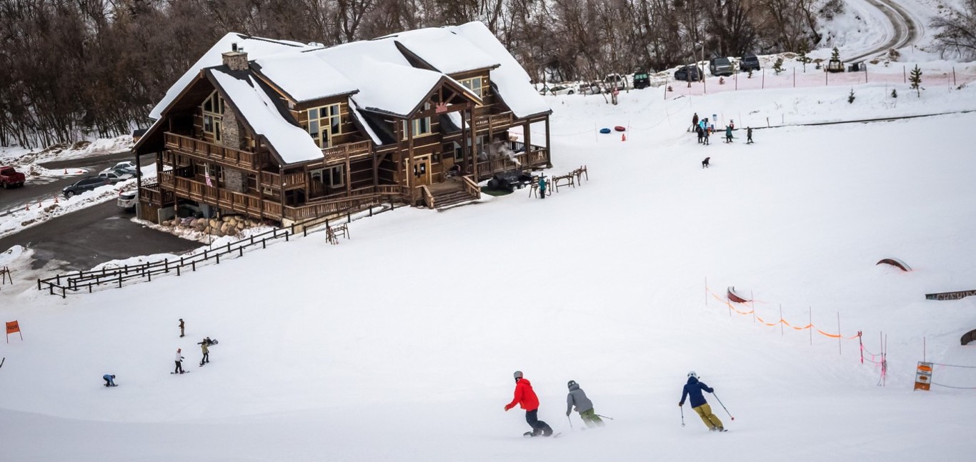 Cherry Peak in USA - a group of people skiing down a hill.