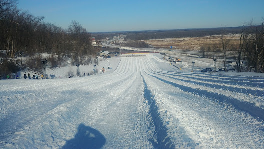 A picturesque view of Cascade Mountain winter sports scene in Portage Wisconsin featuring a bustling ski resort a charming chalet and stunning winter scenery.