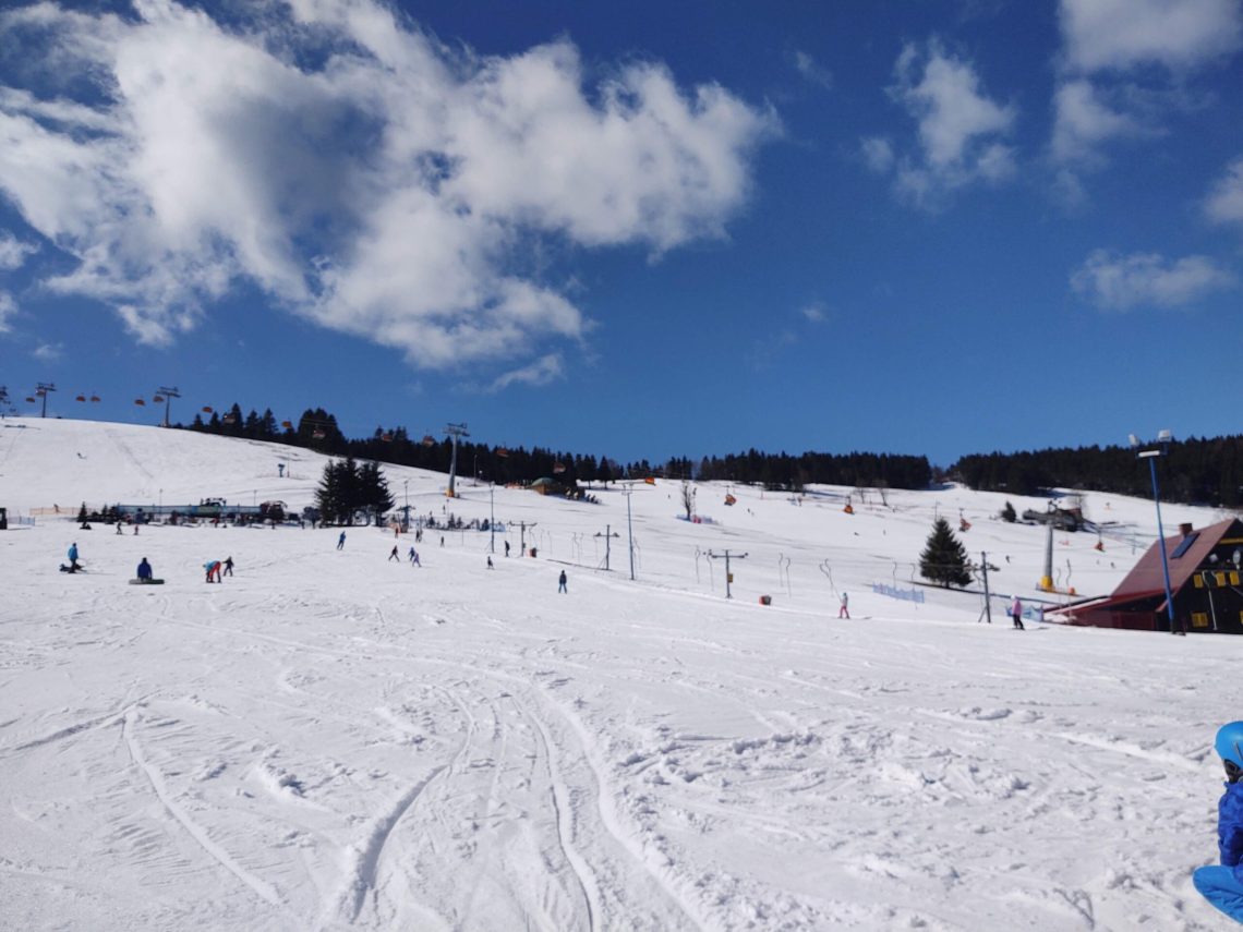 Zieleniec in Poland - a group of people skiing down a snow covered slope.
