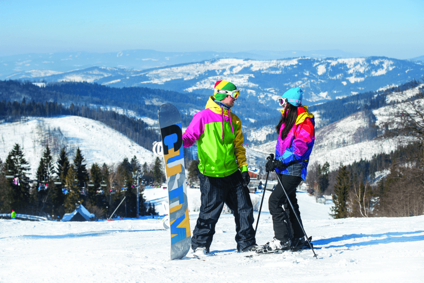 Snowparadise Veľká Rača Oščadnica in Slovakia - two people standing on top of a snow covered hill.