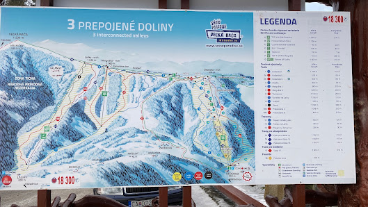 Ski resort in Snowparadise Veľká Rača Oščadnica, Slovakia featuring a chalet, skier, and ski lift amid a winter sports centre.