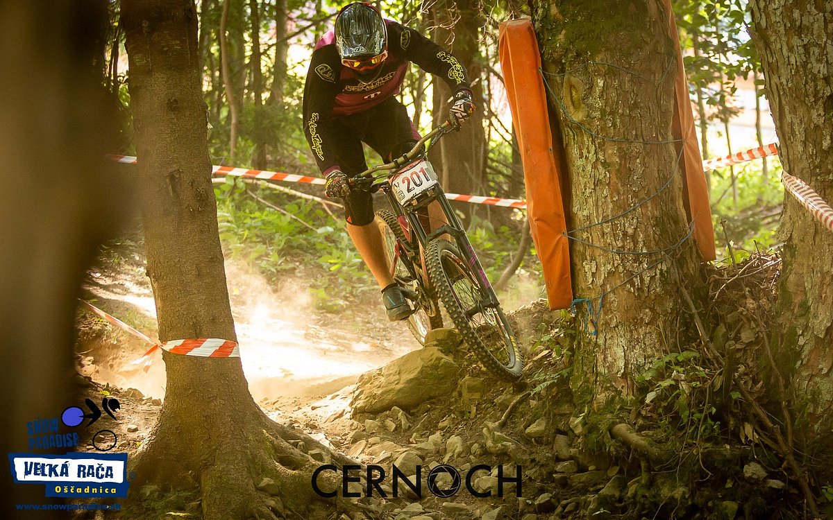 Snowparadise Veľká Rača Oščadnica in Slovakia - a man riding a mountain bike through a forest.