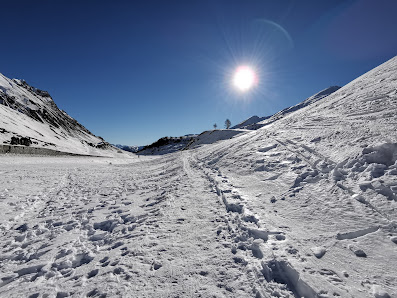 Winter sports scene in Argentera, Piedmont, Italy showcasing a charming chalet nestled amidst stunning, snow-blanketed mountainous scenery.