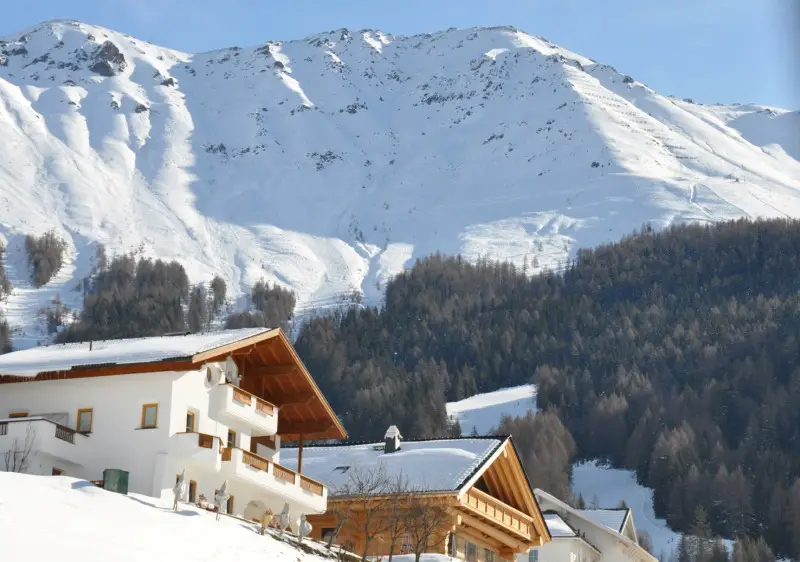 View of Fendels ski resort in Tyrol, Austria, featuring a charming challet amidst a stunning winter scene, frequented by winter sports enthusiasts.