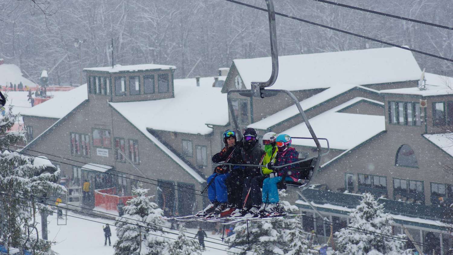 Shawnee Mountain in USA - a group of people riding a ski lift in the snow.