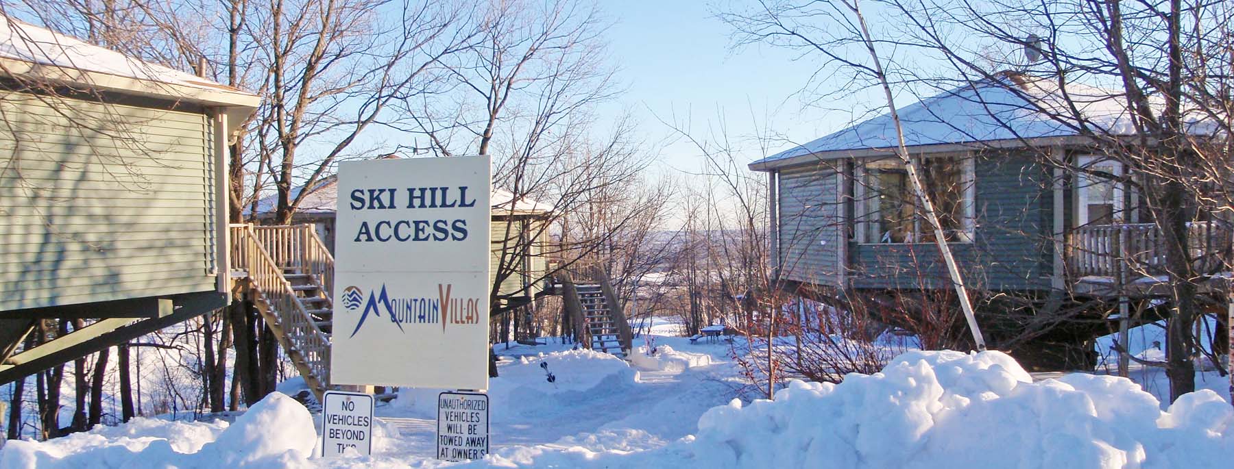 Spirit Mountain in USA - a sign in front of a house in the snow.