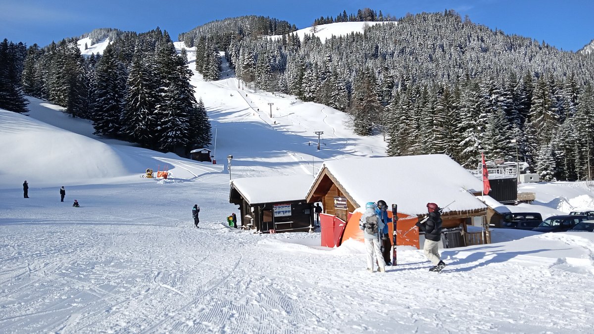 Robella Val-de-Travers in Switzerland - a group of people standing on top of a snow covered slope.