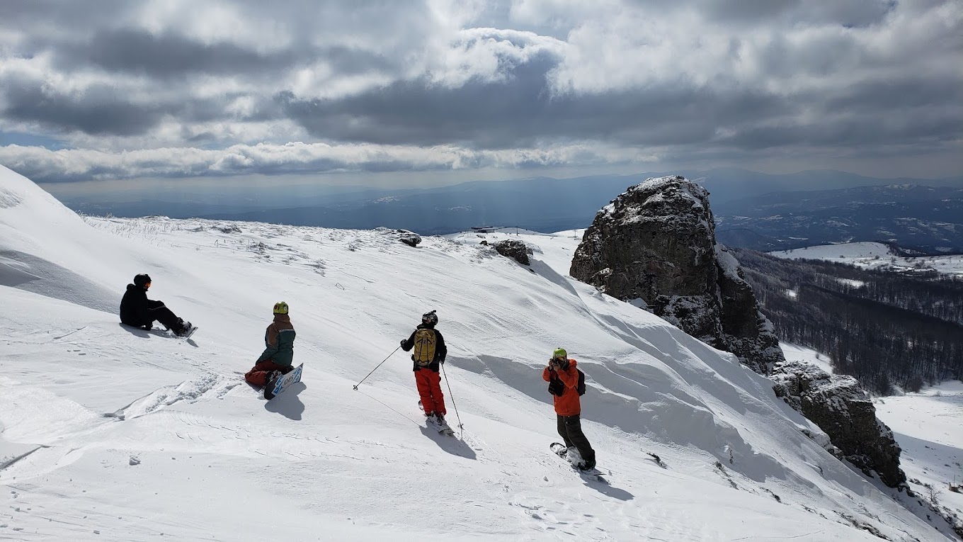 Stara Planina in Serbia - a group of people skiing down a snowy mountain.