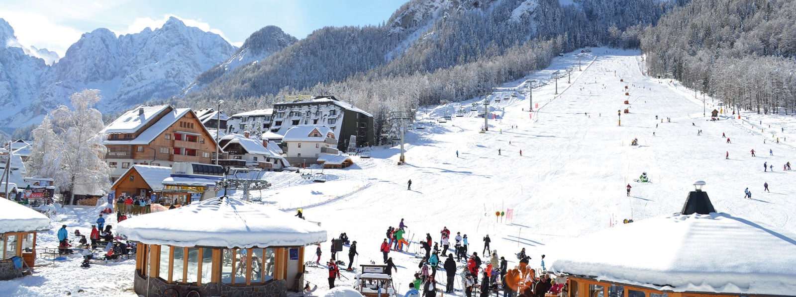 Kranjska Gora in Slovenia - a group of people walking down a snowy slope.