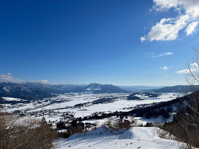 Challet nestled amidst a stunning winter scenery at Togari Onsen ski resort in Nagano, Japan. A vibrant winter sports scene completes the picture-perfect setting.