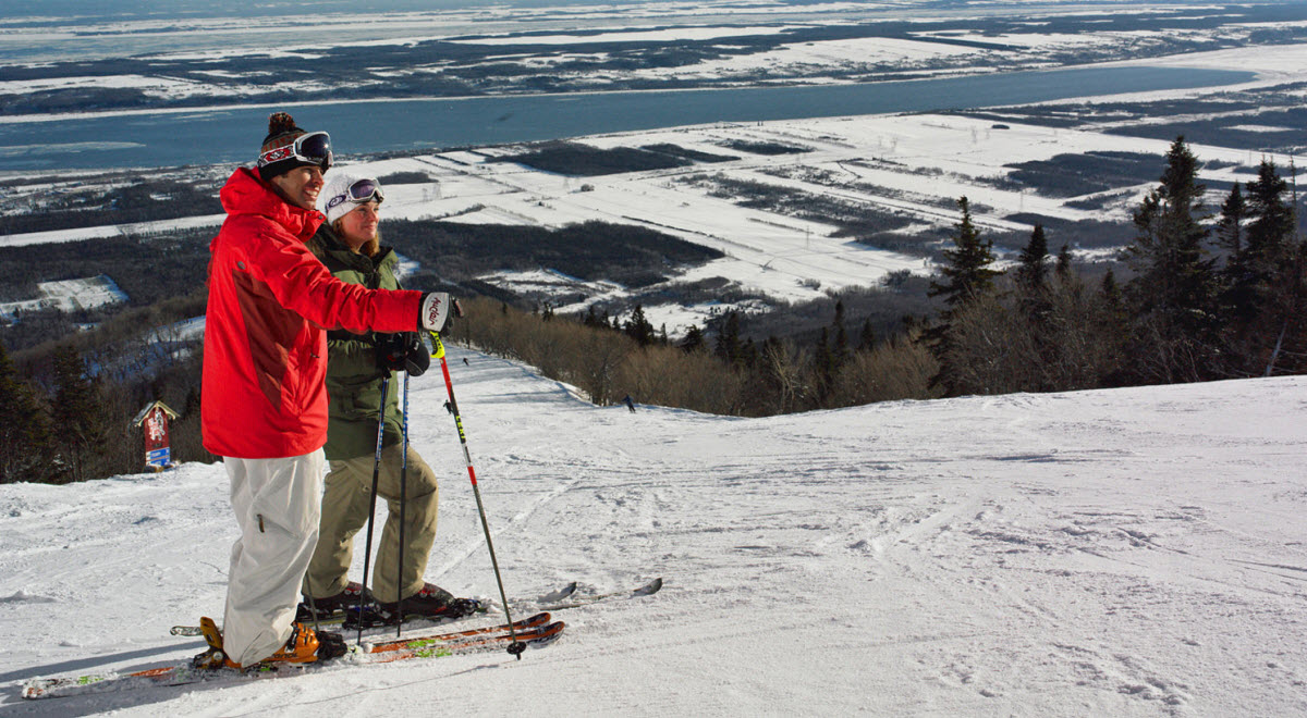 Mont Cascades in Canada - a man standing on top of a snow covered hill.