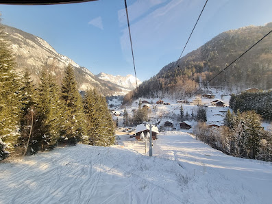 Image of the Télécabine de l'Essert, featuring a charming chalet and a ski lift, set against the picturesque winter backdrop of the Savoie Mont Blanc resort in Abondance, France.