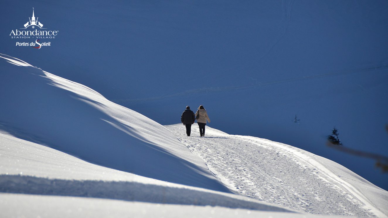 Télécabine de l'Essert in France - a person walking up a snow covered hill.