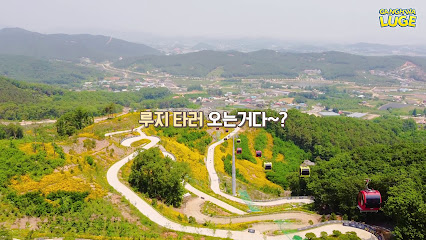 Breathtaking winter view of Ganghwa Seaside Resort, South Korea. The image captures a picturesque mountain scene, a cozy challet, and a ski resort, indicative of an inviting cold-weather retreat.