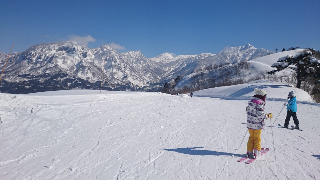 Itoigawa Seaside Valley in Japan - a group of people skiing down a snowy slope.