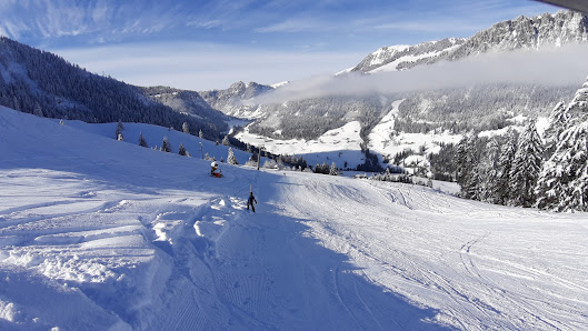 Winter sports scene at Wiriehornbahnen ski resort in Diemtigen, Bernese Oberland, Switzerland featuring a charming challet and stunning winter scenery.