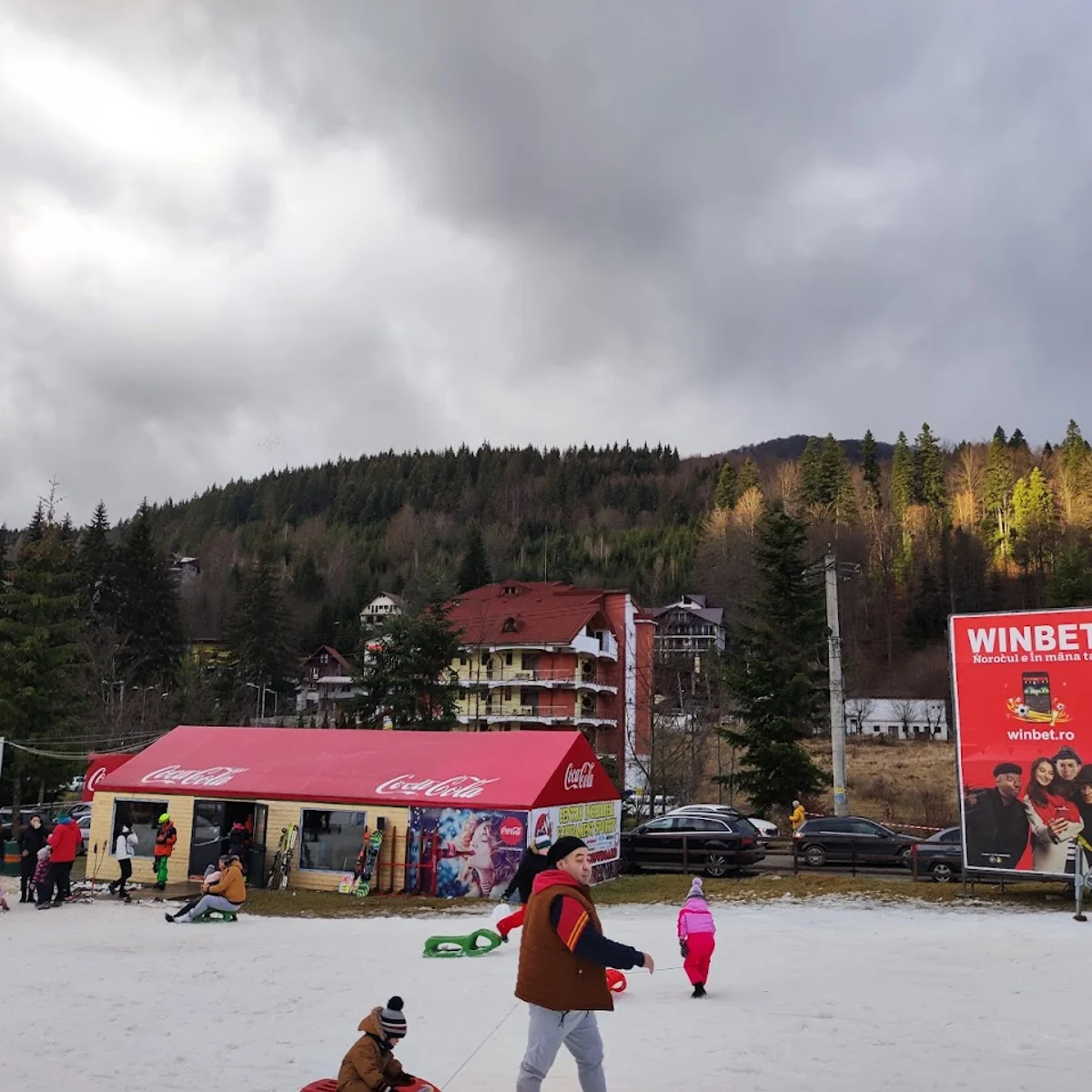 Clăbucet in Romania - a group of people skiing down a snow covered slope.
