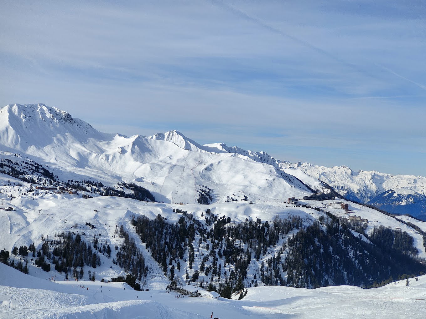 La Plagne in France - a person skiing down a snowy slope in the mountains.