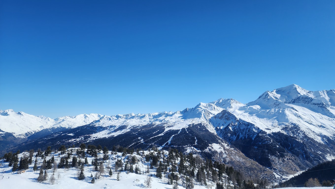 La Plagne in France - a view from the top of a snowy mountain.