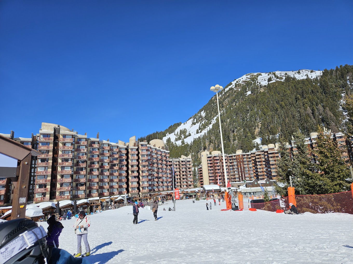 La Plagne in France - a group of people skiing down a snow covered slope.