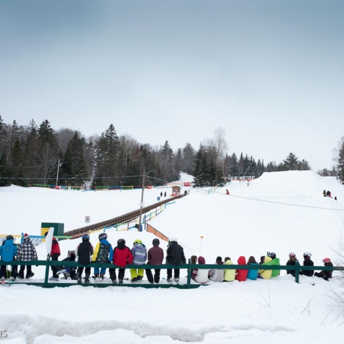 Belle Neige in Canada - a group of people sitting in the snow.
