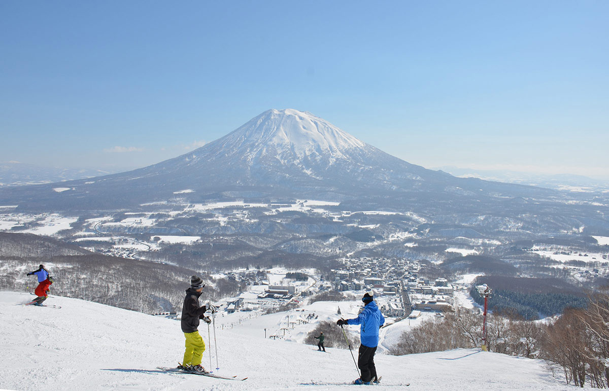 Niseko United in Japan - a group of people standing on top of a snow covered mountain.