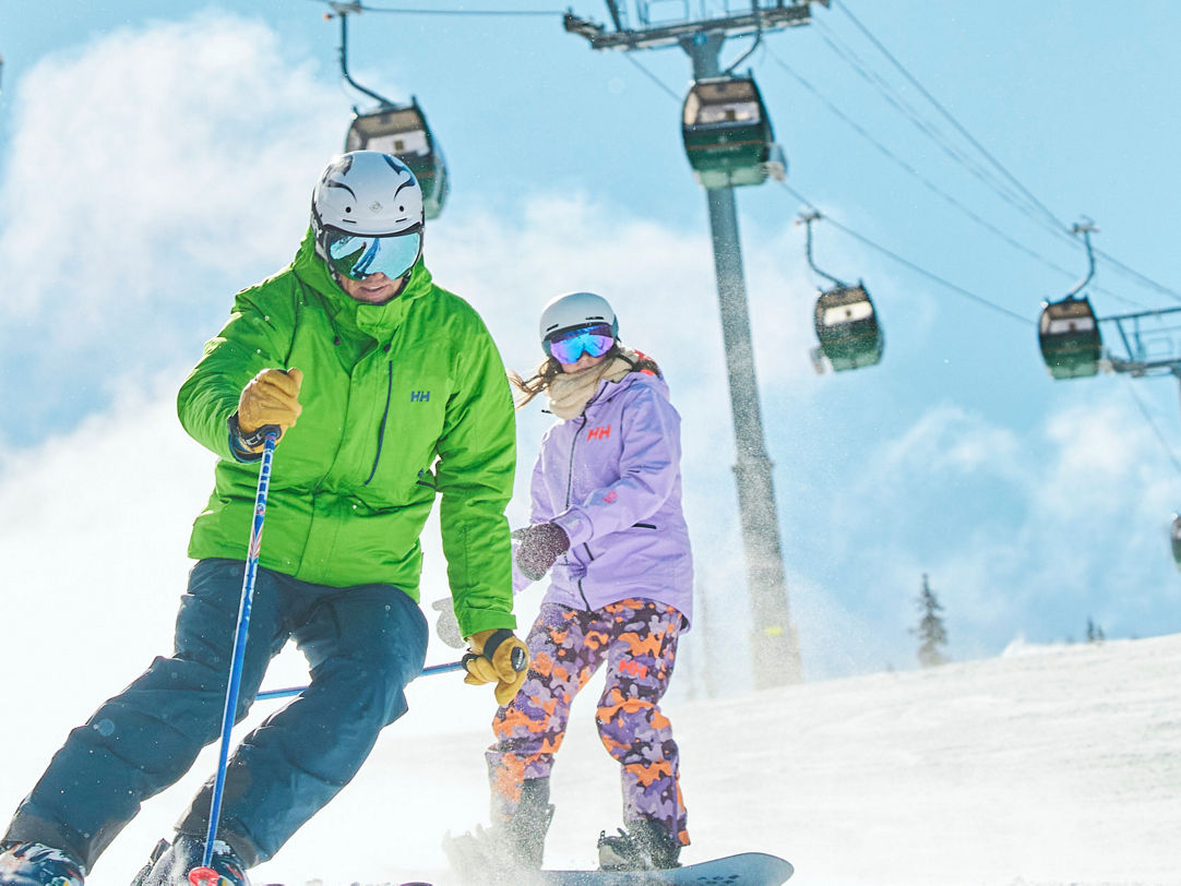 Sun Alpina Hakuba Sanosaka Snow Resort in Japan - a man and a little girl skiing down a mountain.