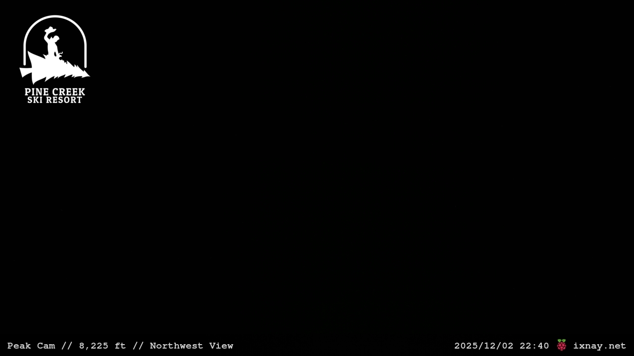 Pine Creek in USA - a man riding a ski board on top of a hill.