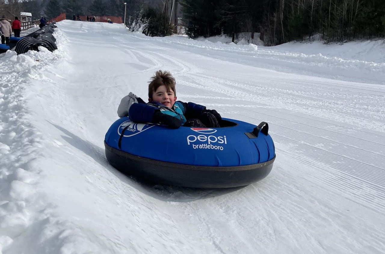 Berkshire East in USA - a young boy is tubling down a hill.