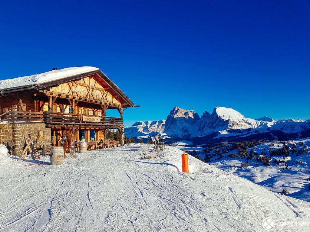 Alpe di Siusi in Italy - a house on a snowy slope in the mountains.