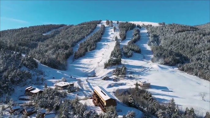 Image of the Grand Puy ski resort in France, showcasing a stunning winter landscape with a ski lift and chalet nestled amongst the snow-covered mountains.