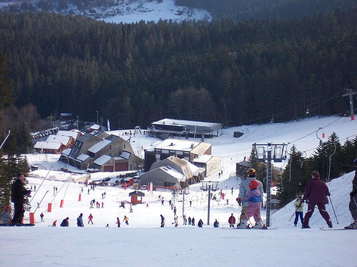 Chalmazel in France - a group of people skiing down a snowy hill.