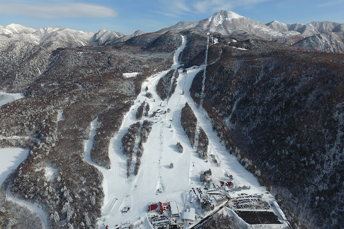 Marunuma Kogen in Japan - a view of a snowy mountain with a ski area.