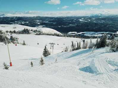 A vibrant ski resort in Åre Duved Northern Sweden. Skiers enjoy the snow-covered slopes using the ski lift for the uphill climb in a picturesque winter sports scene.