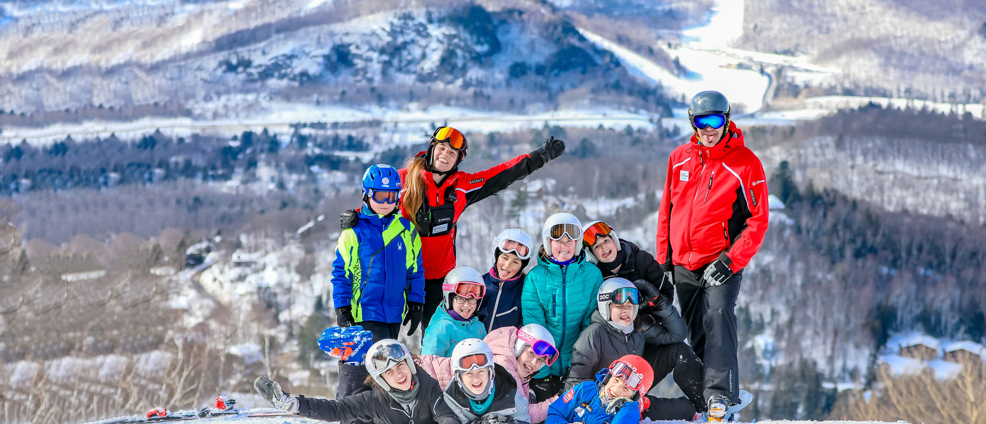 Sommet Olympia in Canada - a group of people standing on top of a snow covered hill.