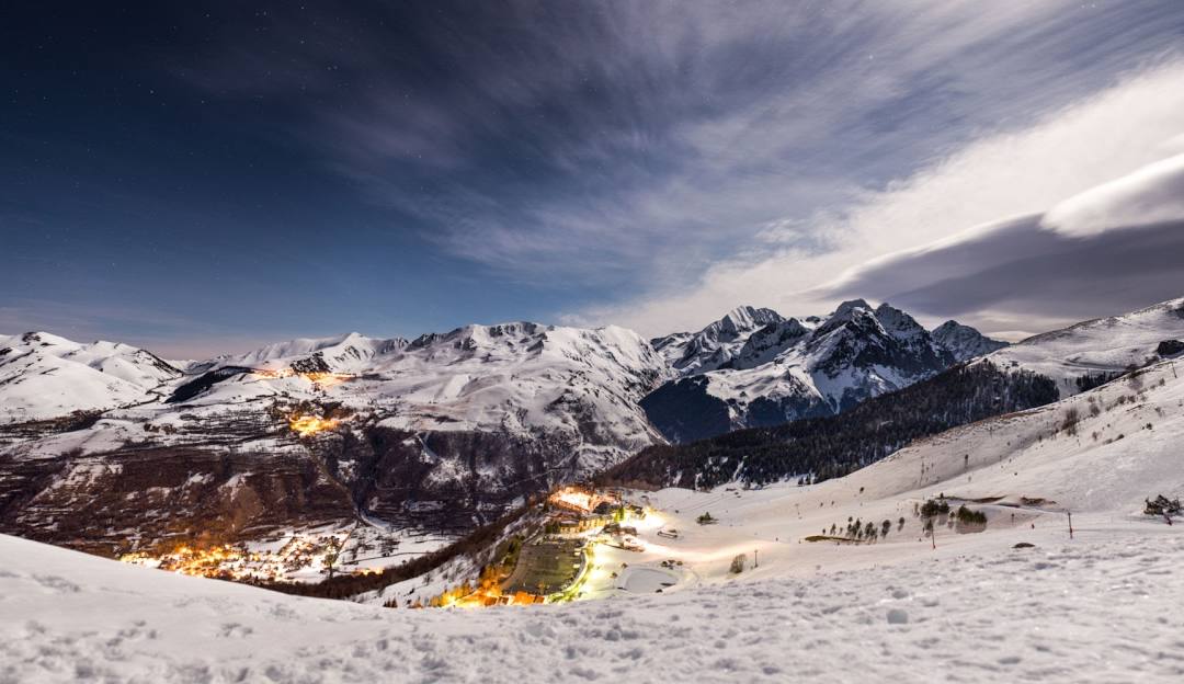 View of Val Louron ski resort in France, featuring snow-covered slopes, a chalet, and other winter sports enthusiasts enjoying the stunning winter scenery.