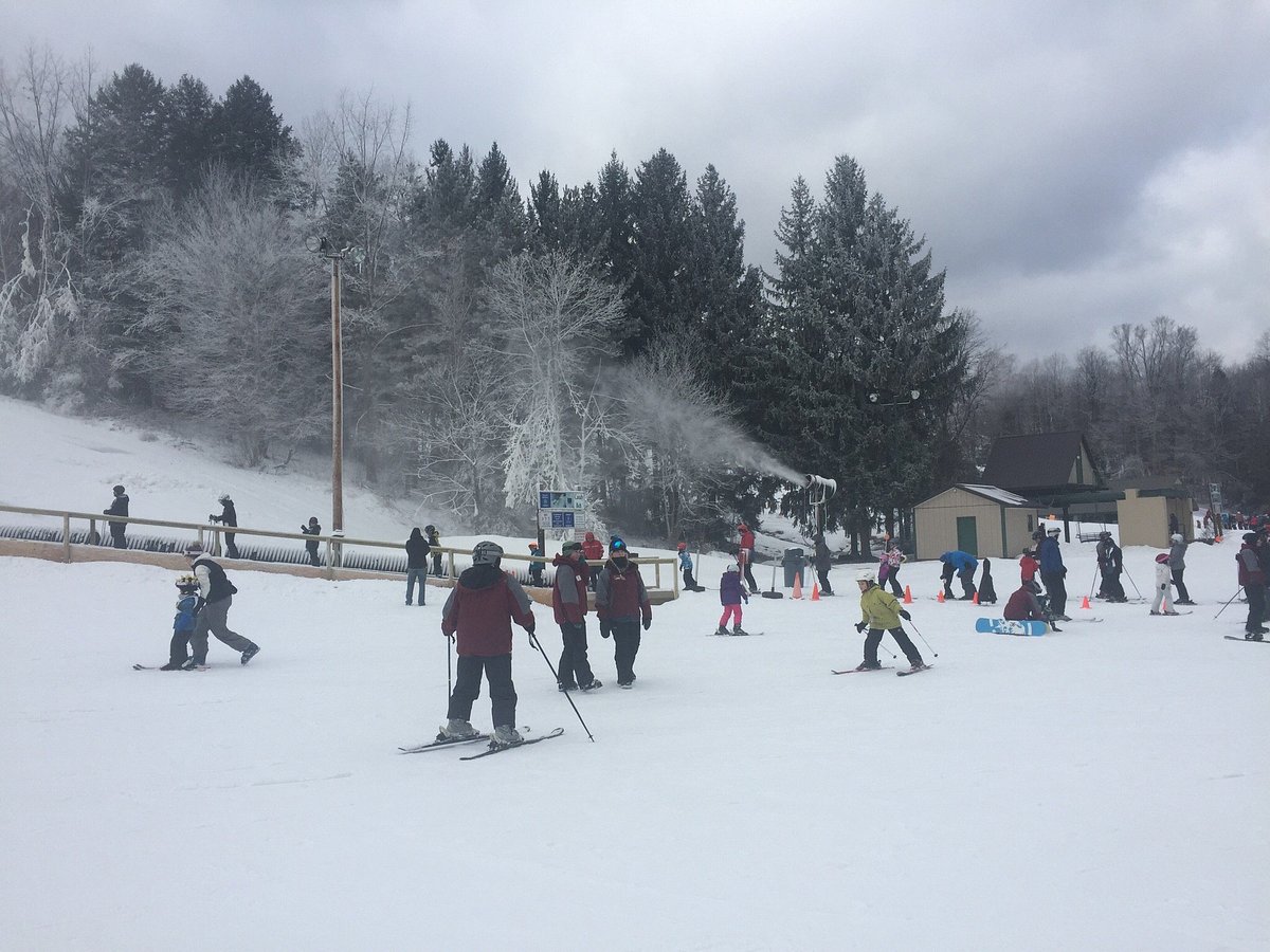 Kissing Bridge in USA - a group of people skiing down a snowy slope.
