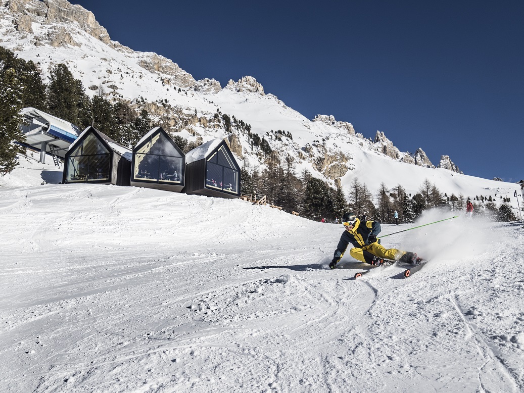 Ski Center Latemar in Italy - a person skiing down a snow covered hill.